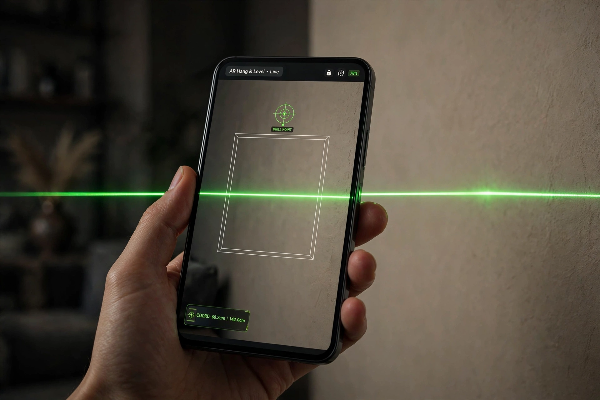 Hand holding a phone showing the Art Level app: green laser datum line, virtual frame outline, drill-point crosshair and coordinate readout over a living room wall